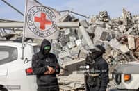 PALESTINIAN-ISRAEL-CONFLICT
Palestinian Hamas militants secure the area as Egyptian workers accompanied by members of the International Committee of the Red Cross (ICRC) search for the remains of the last Israeli hostage in the Zeitoun neighbourhood of Gaza City on December 8, 2025. Qatar and Egypt, guarantors of the Gaza ceasefire, called for the withdrawal of Israeli troops and the deployment of an international stabilisation force as the necessary next steps in fully implementing the fragile agreement. The measures were spelt out in the US- and UN-backed peace plan that has largely halted fighting, though the warring parties have yet to agree on how to move forward from the deal's first phase. Its initial steps saw Israeli troops pull back behind a so-called "yellow line" within Gaza's borders, while Palestinian militant group Hamas released the living hostages it still held and handed over the remains of all but one of the deceased.