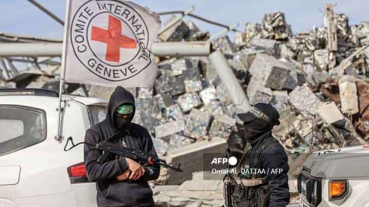 PALESTINIAN-ISRAEL-CONFLICT
Palestinian Hamas militants secure the area as Egyptian workers accompanied by members of the International Committee of the Red Cross (ICRC) search for the remains of the last Israeli hostage in the Zeitoun neighbourhood of Gaza City on December 8, 2025. Qatar and Egypt, guarantors of the Gaza ceasefire, called for the withdrawal of Israeli troops and the deployment of an international stabilisation force as the necessary next steps in fully implementing the fragile agreement. The measures were spelt out in the US- and UN-backed peace plan that has largely halted fighting, though the warring parties have yet to agree on how to move forward from the deal's first phase. Its initial steps saw Israeli troops pull back behind a so-called "yellow line" within Gaza's borders, while Palestinian militant group Hamas released the living hostages it still held and handed over the remains of all but one of the deceased.