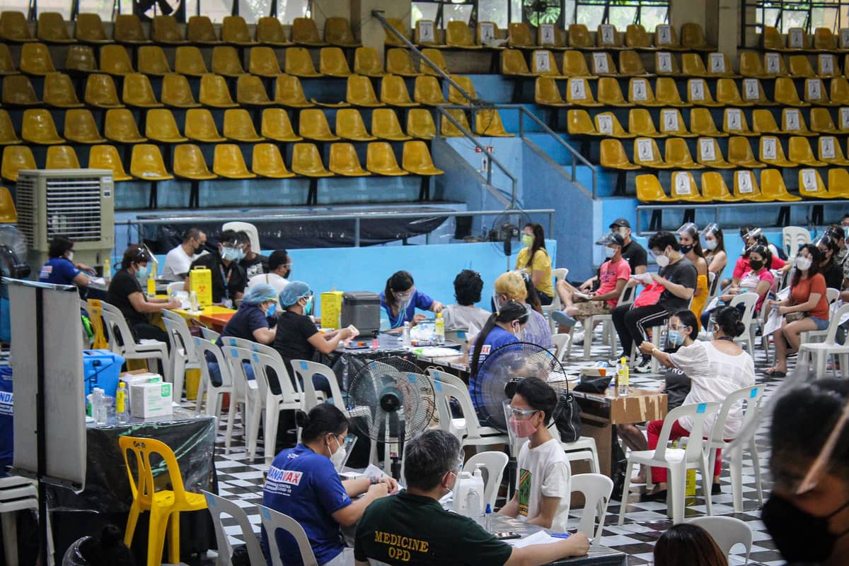 FILIPINOS receive Covid-19 vaccine.