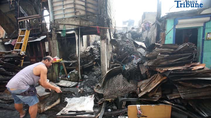 RESIDENTS comb through the aftermath of the Mandaluyong fire.