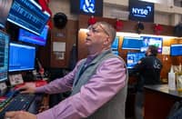 STOCK trader checks share prices on the floor of the New York Stock Exchange. The Dow Jones Industrial Average hit new highs last week but the mood shifted, motivated by unease about potentially excessive stock valuations in the tech sector.