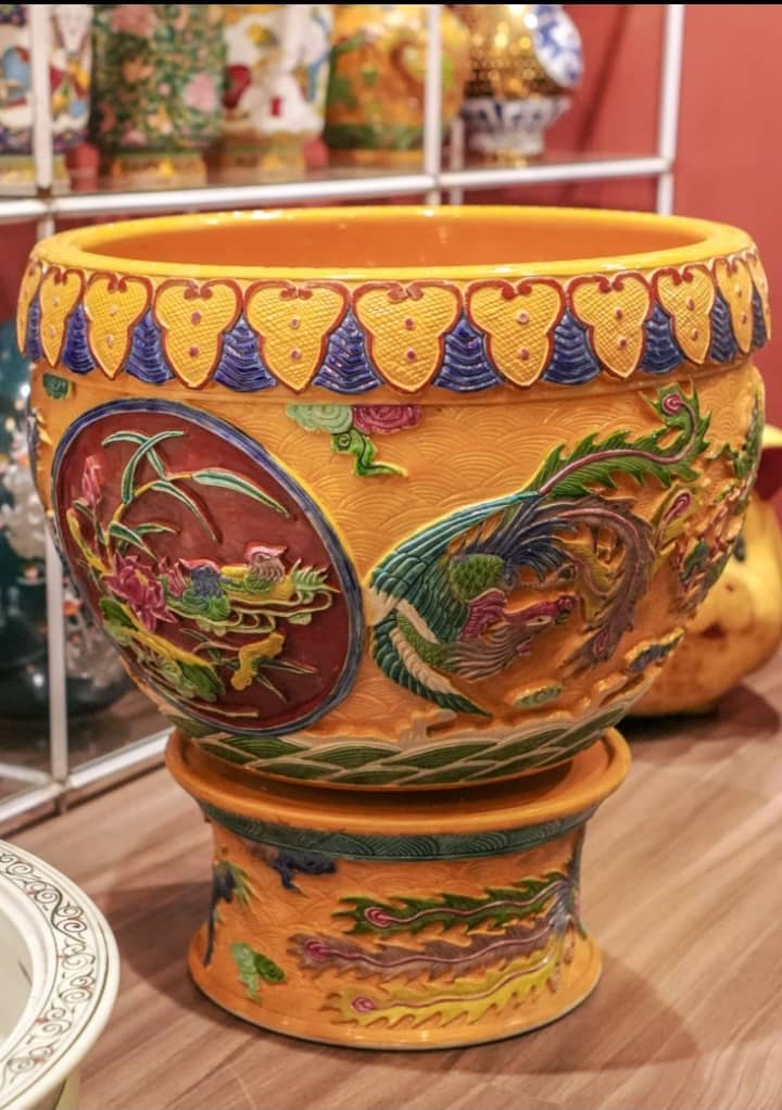 A richly detailed porcelain basin adorned with dragons and floral medallions.