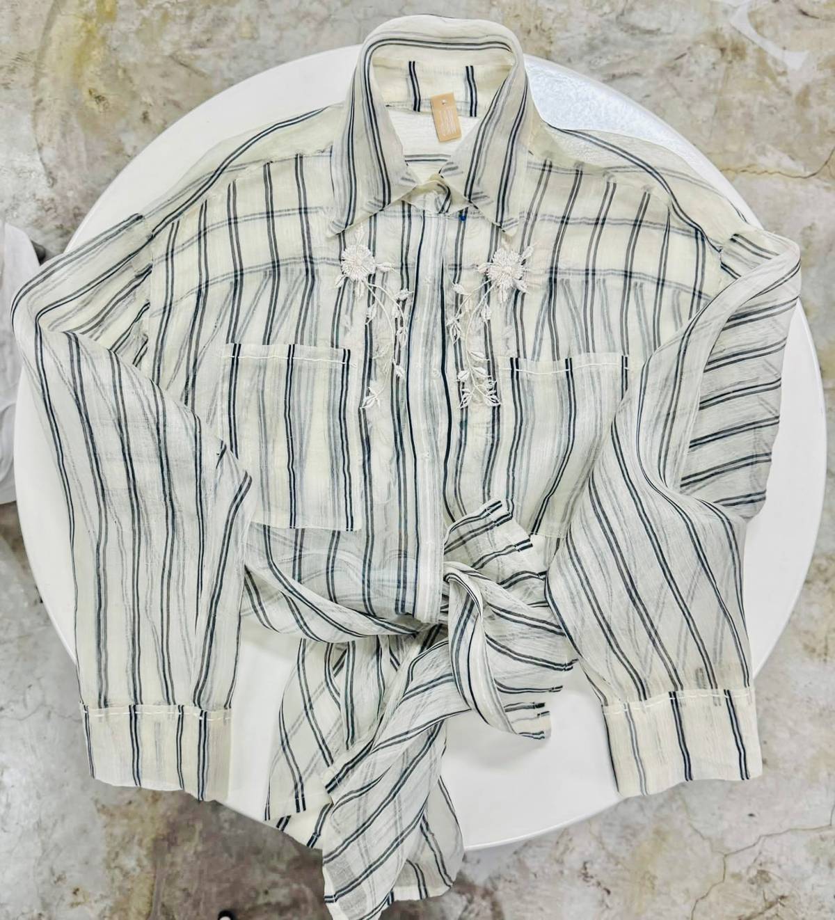 FROM 2019 a Tan-Gan Piña shirt featuring pockets, hand-woven in indigenous Piña and detailed with hand embroidery and precise topstitching.