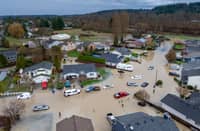 A NEIGHBORHOOD is engulfed in floodwater on 16 December 2025 in Pacific, Washington. Evacuations have been ordered in three suburbs south of Seattle after recent levee failure. Mass flooding along the Pacific Northwest caused historic flooding, tens of thousands of evacuations, and dozens of Coast Guard rescues.