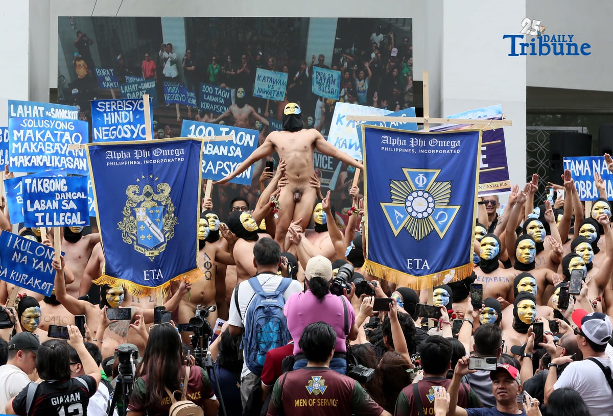 (December 17 2025) Hundreds of Alpha Phi Omega Philippines (APO) fraternity members run naked while carrying placards showing their protest against the government on the alleged flood control projects, at the University of the Philippines UP Diliman Quezon City, on Wednesday December 17 2025, during their 100 year's celebration. Photo/Analy Labor