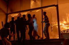 Buildings burn as youth leader dies