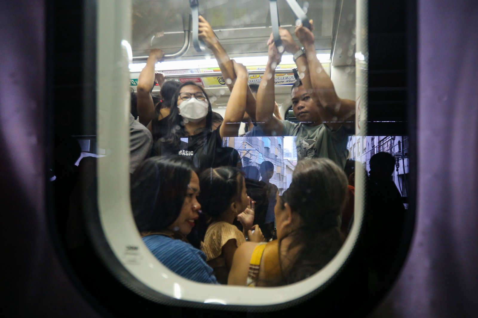 Commuters board an LRT-1 train at Doroteo Jose Station in Manila on Sunday afternoon, December 21, as the Department of Transportation rolls out its “12 Days of Christmas” free-ride program, allowing entire families to ride for free regardless of the number of members.