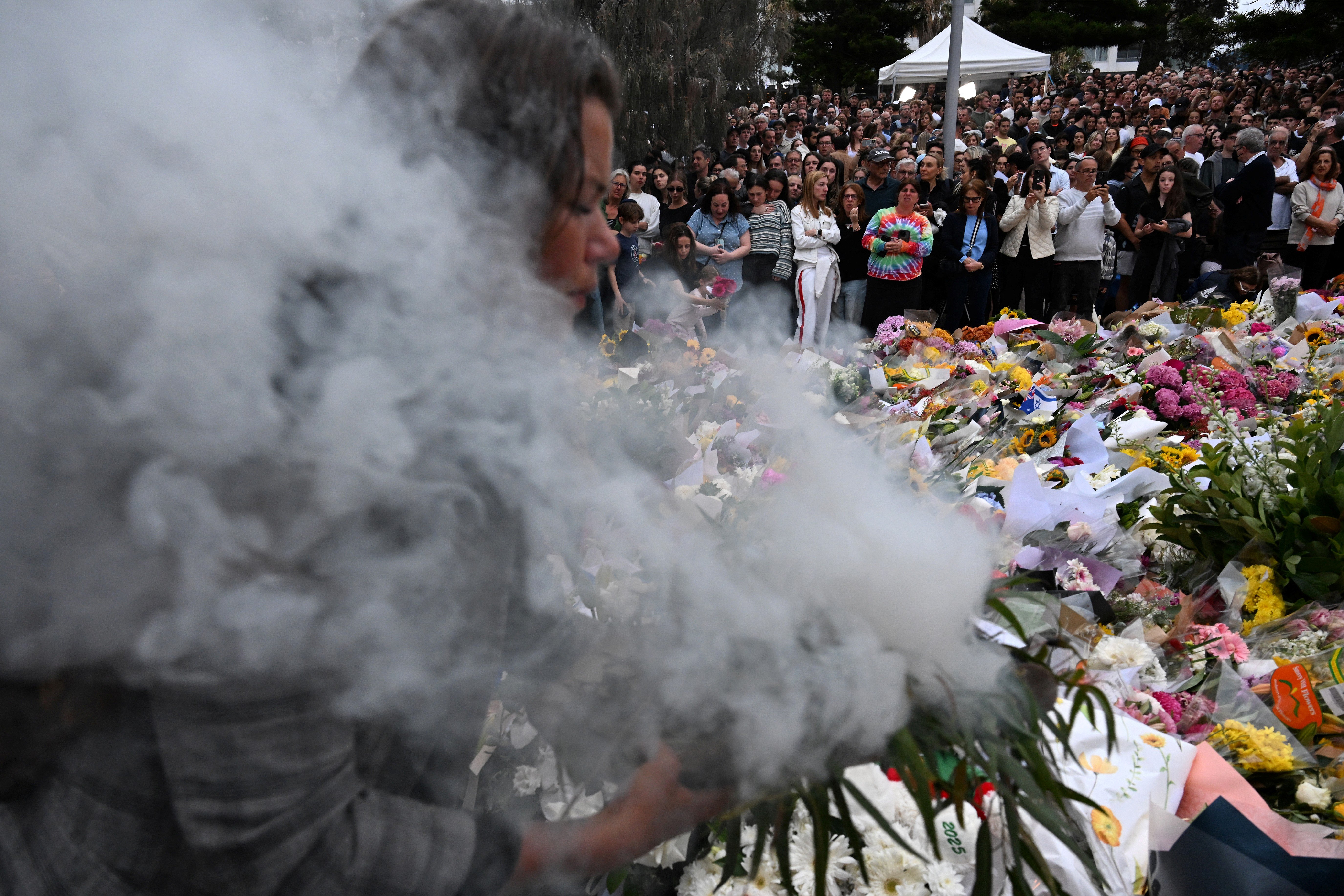 Australia falls silent, lights candles for Bondi Beach shooting victims