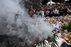 Australia falls silent, lights candles for Bondi Beach shooting victims