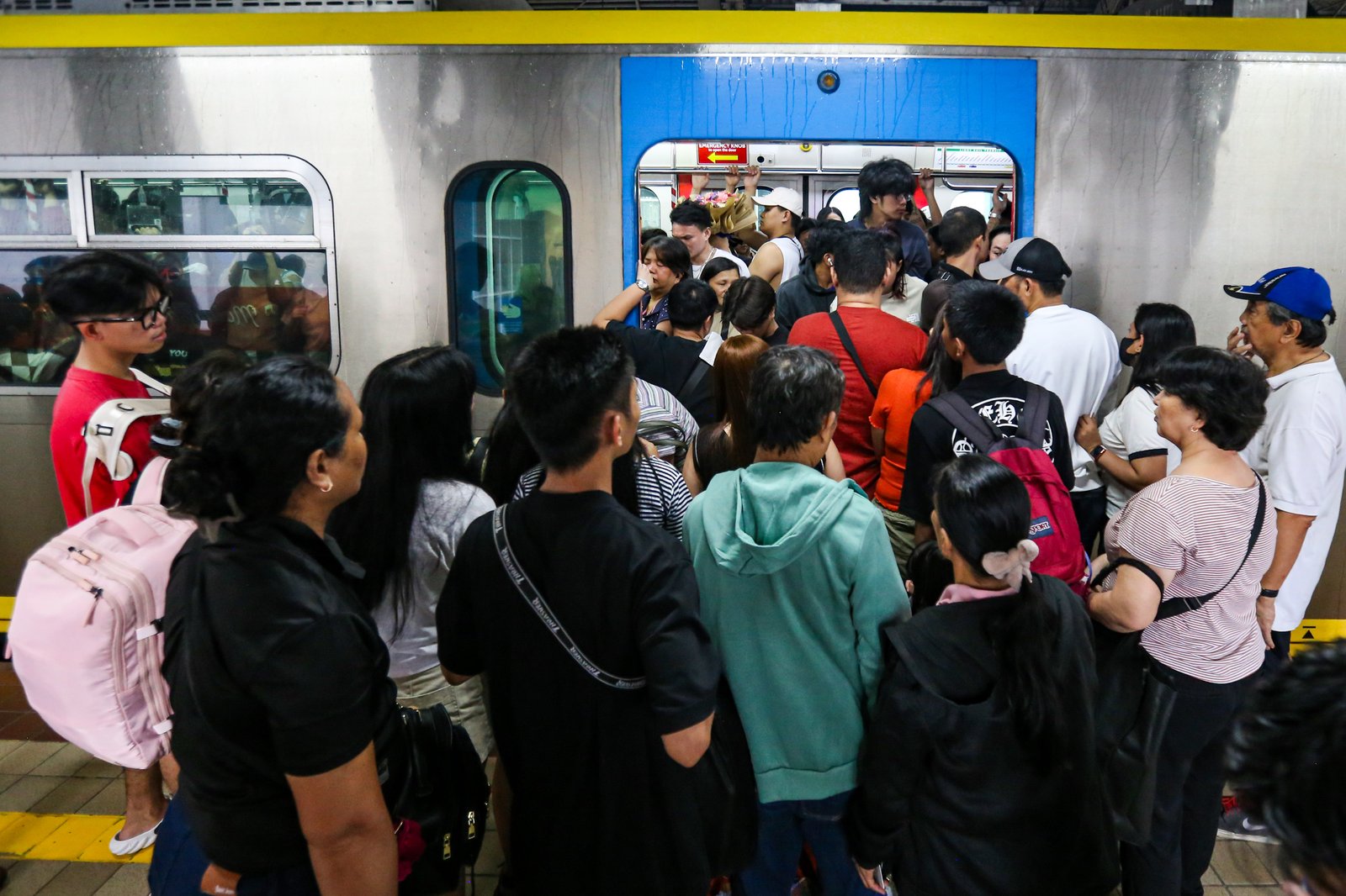 Commuters board an LRT-1 train at Doroteo Jose Station in Manila on Sunday afternoon, December 21, as the Department of Transportation rolls out its “12 Days of Christmas” free-ride program, allowing entire families to ride for free regardless of the number of members.