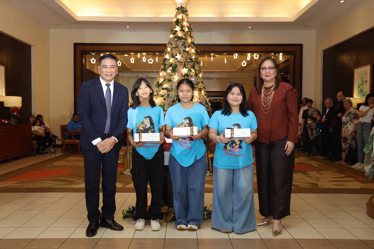 CATHY Nepomuceno and GM Ramon Makilan share a joyful moment during the gift-giving activity with the children of the Augustinian Sisters Servants of Jesus.