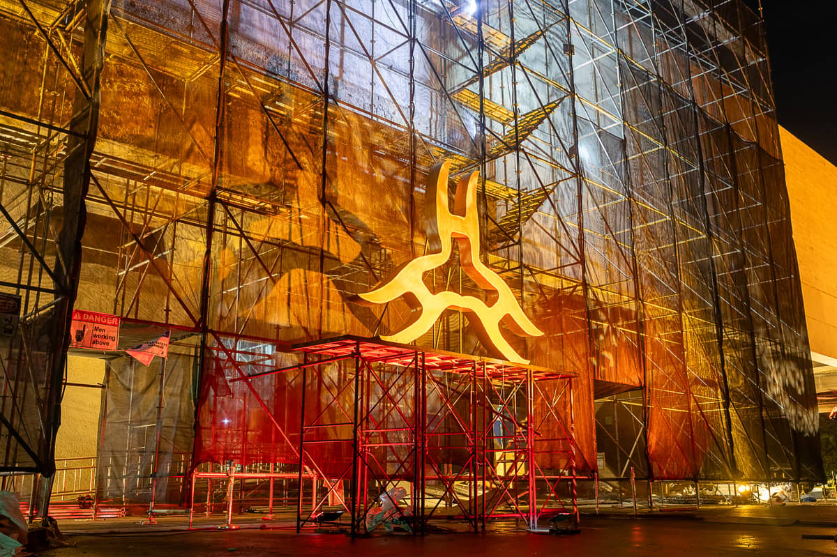 THE illuminated CCP logo shines through scaffolding and steel, symbolizing continuity and resilience amid the building’s ongoing renovation.