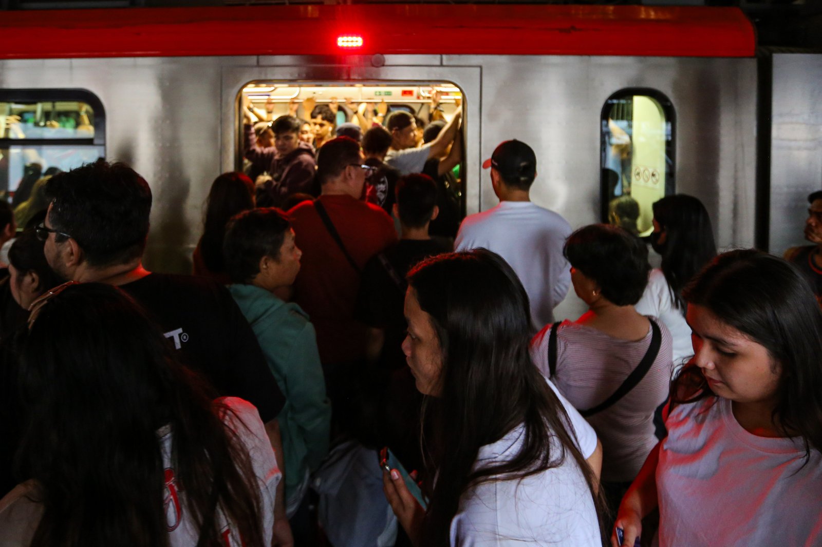 Commuters board an LRT-1 train at Doroteo Jose Station in Manila on Sunday afternoon, December 21, as the Department of Transportation rolls out its “12 Days of Christmas” free-ride program, allowing entire families to ride for free regardless of the number of members.