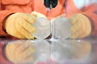 A RESEARCHER cuts a slice from an ice core sample taken from a glacier in the Pamir mountain range in Tajikistan, in a storage freezer chilled to minus 50 Celcius at the Hokkaido University Institute of Low Temperature Science, in Sapporo, Japan on 9 December 2025.