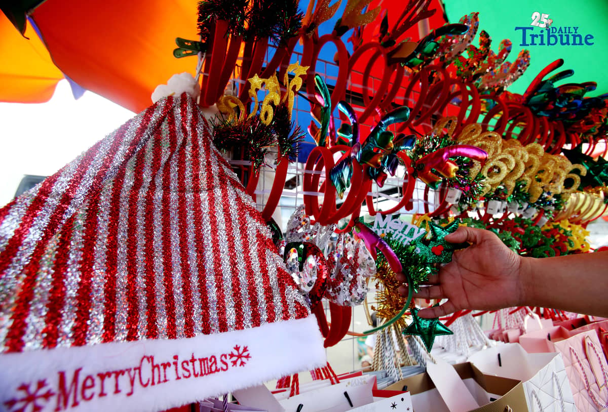 (December 23 2025) Customer looked at the colourful Christmas accessories to buy at Commonwealth Market in Quezon City, on Tuesday December 23 2025, two days before Christmas. Photo/Analy Labor