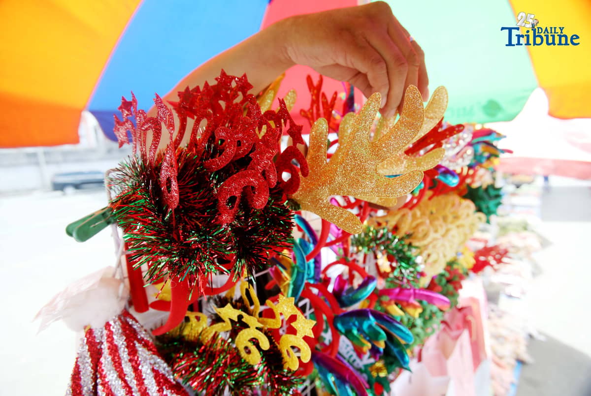 (December 23 2025) Customer looked at the colourful Christmas accessories to buy at Commonwealth Market in Quezon City, on Tuesday December 23 2025, two days before Christmas. Photo/Analy Labor