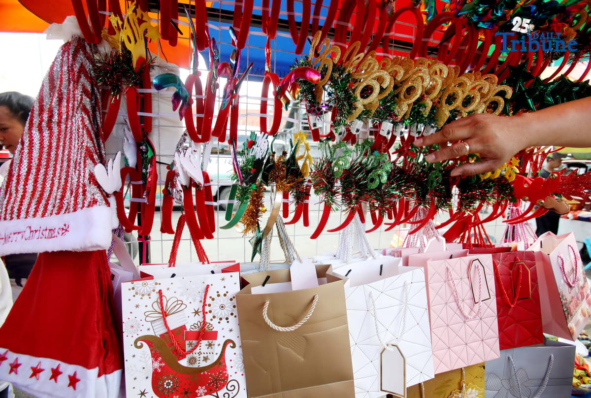 (December 23 2025) Customer looked at the colourful Christmas accessories to buy at Commonwealth Market in Quezon City, on Tuesday December 23 2025, two days before Christmas. Photo/Analy Labor
