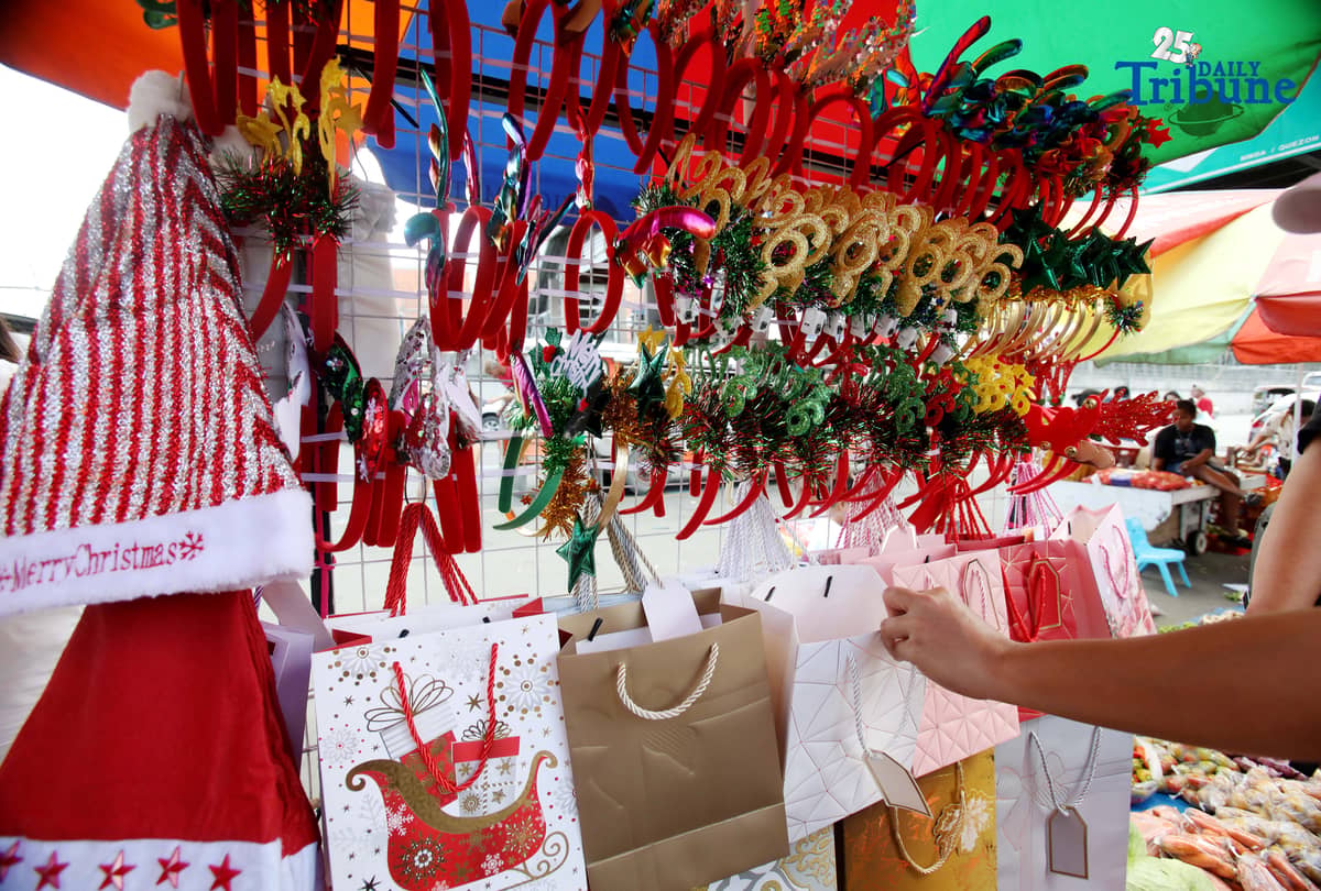 (December 23 2025) Customer looked at the colourful Christmas accessories to buy at Commonwealth Market in Quezon City, on Tuesday December 23 2025, two days before Christmas. Photo/Analy Labor