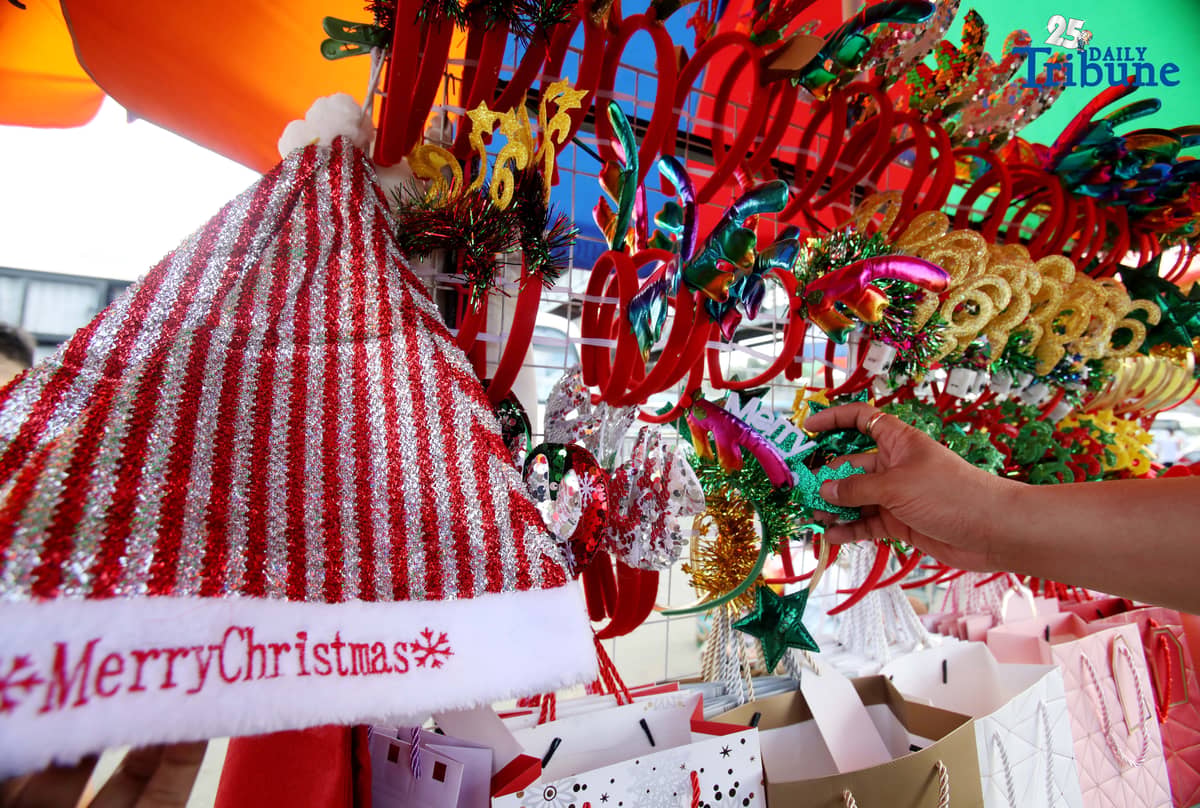 (December 23 2025) Customer looked at the colourful Christmas accessories to buy at Commonwealth Market in Quezon City, on Tuesday December 23 2025, two days before Christmas. Photo/Analy Labor