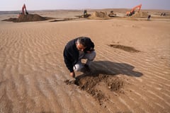 Iraqis cover soil with clay to curb sandstorms