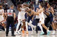 Jose Alvarado #15 of the New Orleans Pelicans gets into a scrum with Mark Williams #15 of the Phoenix Suns during the second half of a game at Smoothie King Center on December 27, 2025 in New Orleans, Louisiana.