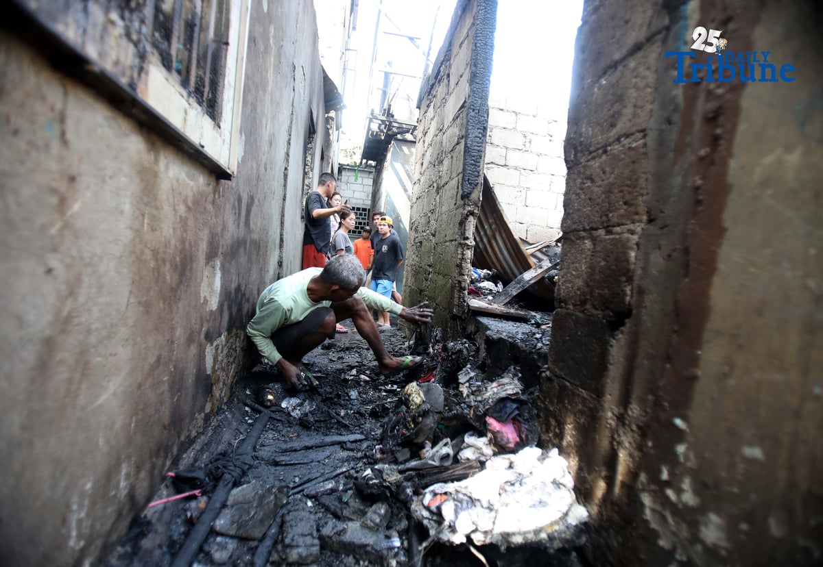 Residents affected by a fifth-alarm fire at Riverside Extension, San Roque Street, Barangay Commonwealth, Quezon City were seen on Monday, December 29, 2025, salvaging reusable belongings from the ruins of their homes. The blaze, which broke out Sunday night, December 28, affected more than 50 houses and displaced around 100 families, or about 500 individuals.