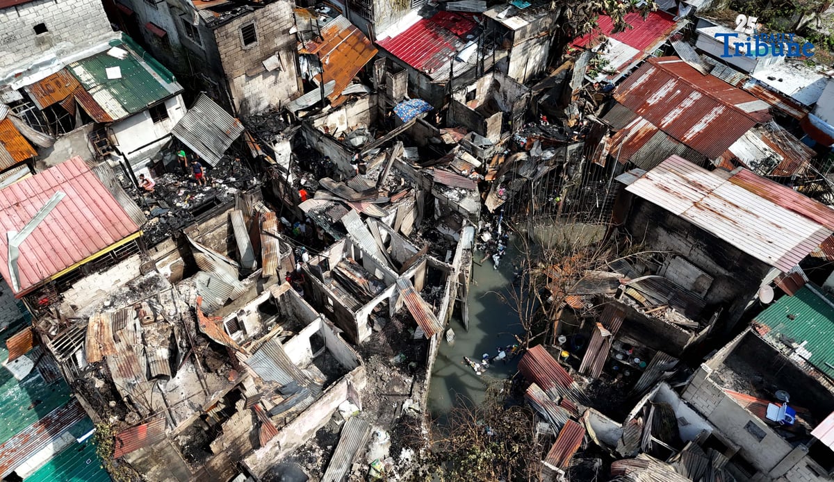 Residents affected by a fifth-alarm fire at Riverside Extension, San Roque Street, Barangay Commonwealth, Quezon City were seen on Monday, December 29, 2025, salvaging reusable belongings from the ruins of their homes. The blaze, which broke out Sunday night, December 28, affected more than 50 houses and displaced around 100 families, or about 500 individuals.