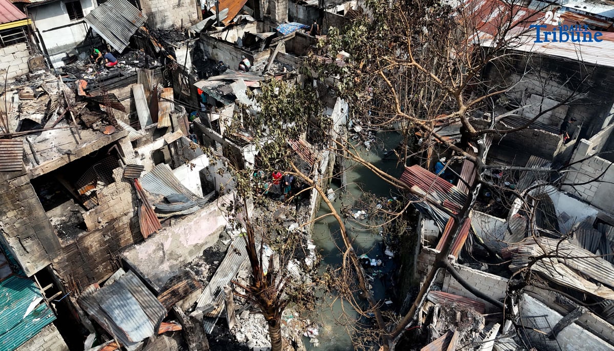 Residents affected by a fifth-alarm fire at Riverside Extension, San Roque Street, Barangay Commonwealth, Quezon City were seen on Monday, December 29, 2025, salvaging reusable belongings from the ruins of their homes. The blaze, which broke out Sunday night, December 28, affected more than 50 houses and displaced around 100 families, or about 500 individuals.