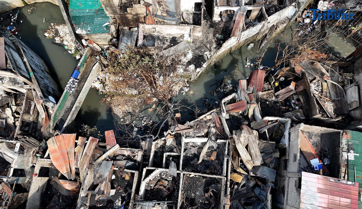 Residents affected by a fifth-alarm fire at Riverside Extension, San Roque Street, Barangay Commonwealth, Quezon City were seen on Monday, December 29, 2025, salvaging reusable belongings from the ruins of their homes. The blaze, which broke out Sunday night, December 28, affected more than 50 houses and displaced around 100 families, or about 500 individuals.