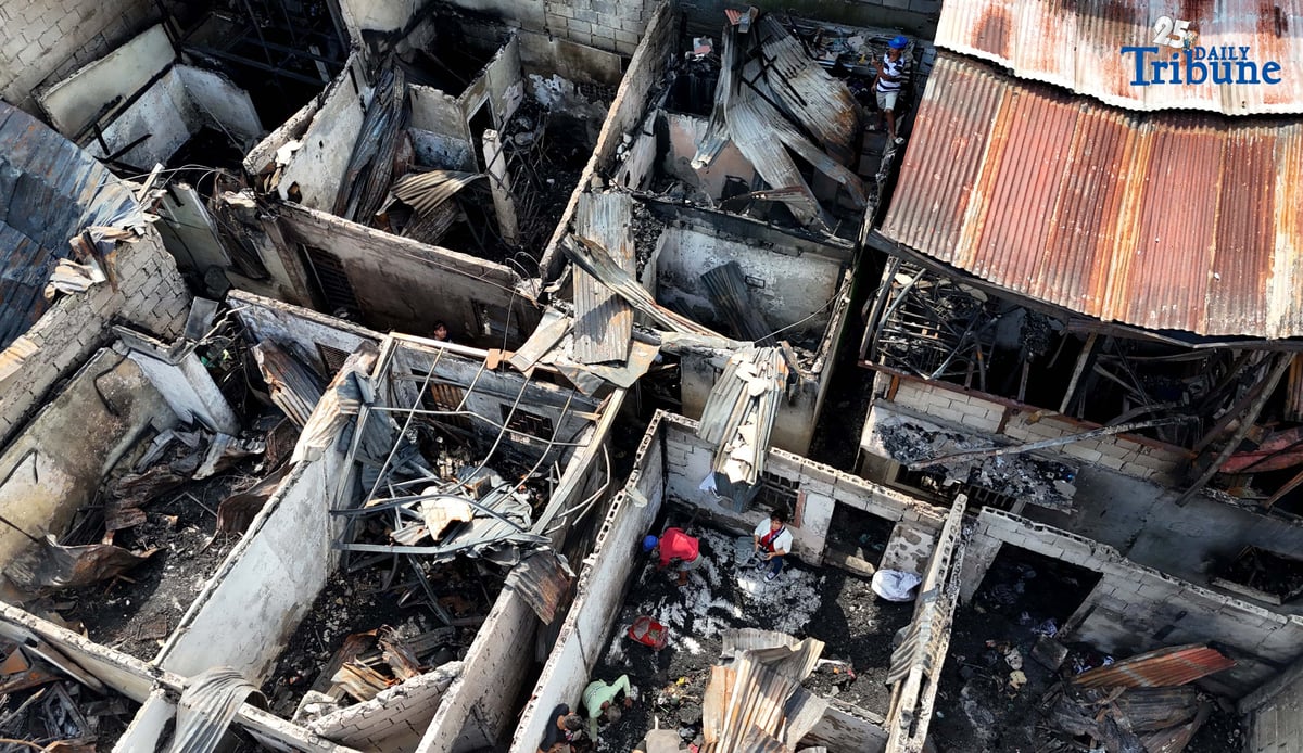 Residents affected by a fifth-alarm fire at Riverside Extension, San Roque Street, Barangay Commonwealth, Quezon City were seen on Monday, December 29, 2025, salvaging reusable belongings from the ruins of their homes. The blaze, which broke out Sunday night, December 28, affected more than 50 houses and displaced around 100 families, or about 500 individuals.