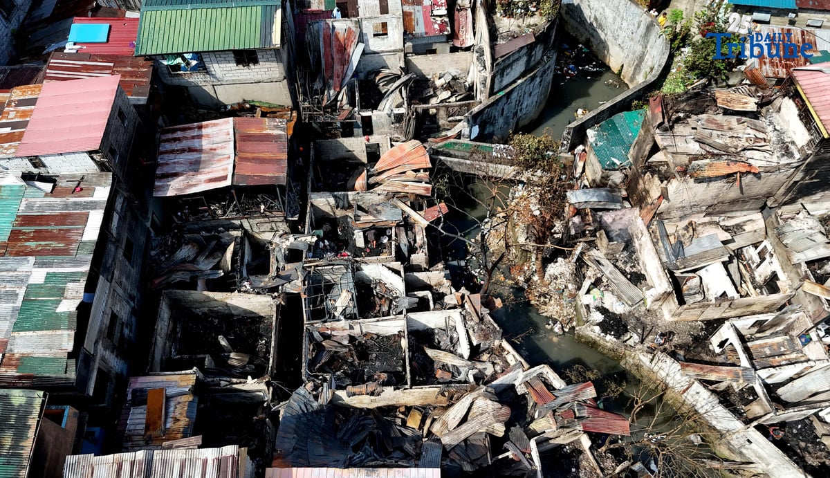 Residents affected by a fifth-alarm fire at Riverside Extension, San Roque Street, Barangay Commonwealth, Quezon City were seen on Monday, December 29, 2025, salvaging reusable belongings from the ruins of their homes. The blaze, which broke out Sunday night, December 28, affected more than 50 houses and displaced around 100 families, or about 500 individuals.