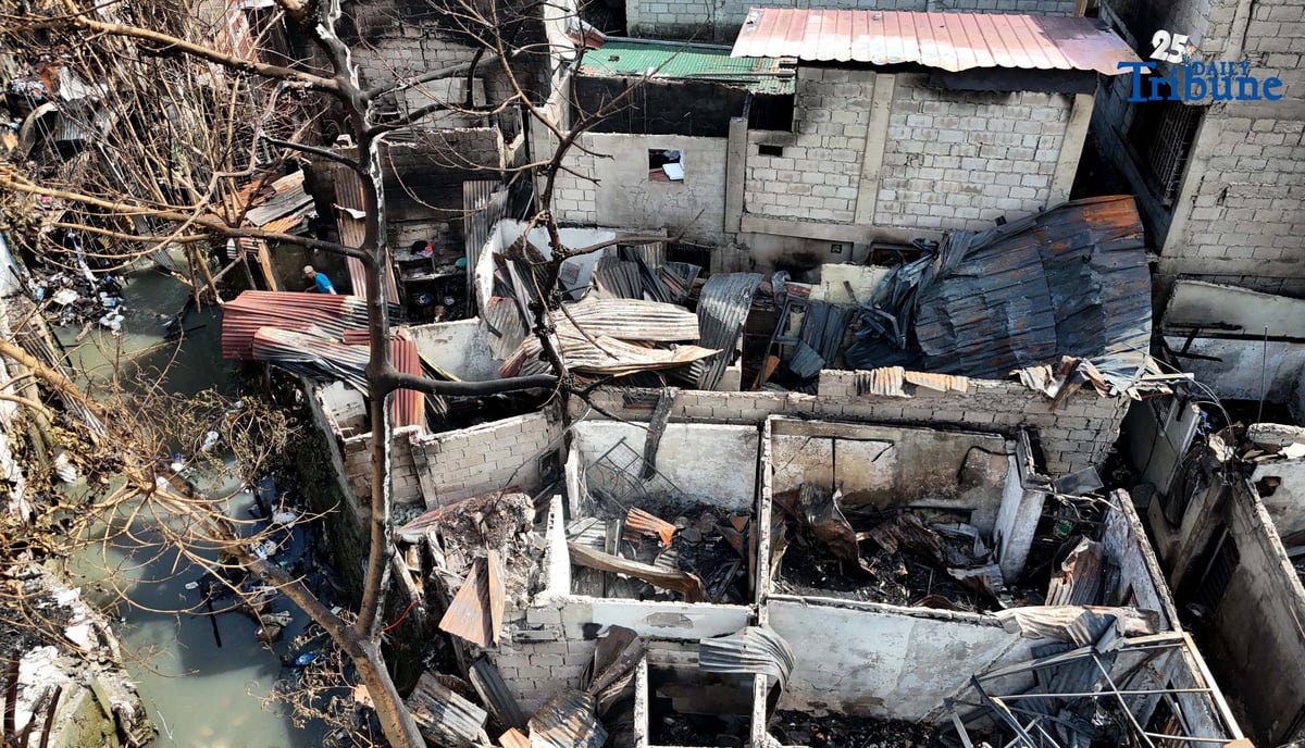 Residents affected by a fifth-alarm fire at Riverside Extension, San Roque Street, Barangay Commonwealth, Quezon City were seen on Monday, December 29, 2025, salvaging reusable belongings from the ruins of their homes. The blaze, which broke out Sunday night, December 28, affected more than 50 houses and displaced around 100 families, or about 500 individuals.