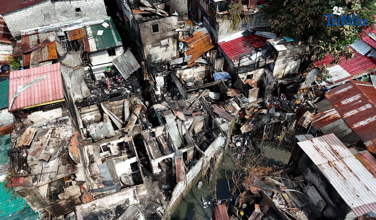 Residents affected by a fifth-alarm fire at Riverside Extension, San Roque Street, Barangay Commonwealth, Quezon City were seen on Monday, December 29, 2025, salvaging reusable belongings from the ruins of their homes. The blaze, which broke out Sunday night, December 28, affected more than 50 houses and displaced around 100 families, or about 500 individuals.