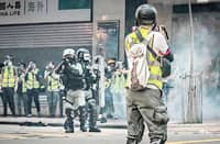 UNDER fire A photojournalist faces a wall of shields in Hong Kong.