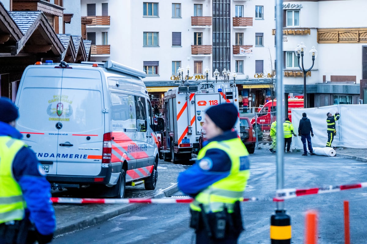 POLICE officers stand guard at the site of an explosion that ripped through the bar Le Constellation in Crans-Montana on 1 January 2026.