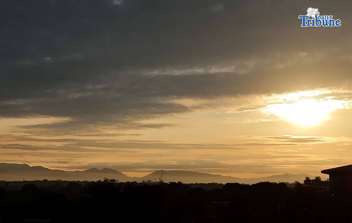 The sun briefly breaks through the clouds before dark skies take over on Thursday, Jan. 1, 2026, as seen from Caloocan City.