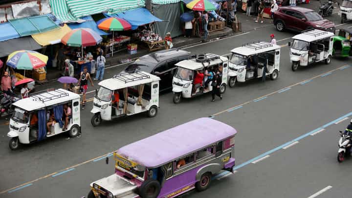 DESPITE the ban on electric bikes and electric trikes imposed by the Land Transportation Office, an e-trike is seen picking up passengers along Commonwealth Avenue in Quezon City on Friday. The LTO announced that it is starting to apprehend violators to improve road safety and traffic flow on major thoroughfares.