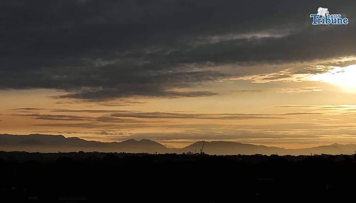 The sun briefly breaks through the clouds before dark skies take over on Thursday, Jan. 1, 2026, as seen from Caloocan City.