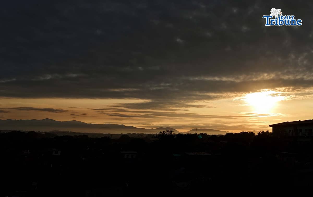 The sun briefly breaks through the clouds before dark skies take over on Thursday, Jan. 1, 2026, as seen from Caloocan City.
