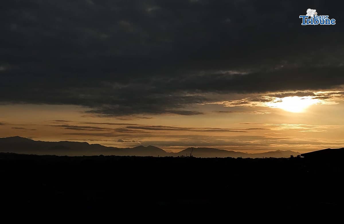 The sun briefly breaks through the clouds before dark skies take over on Thursday, Jan. 1, 2026, as seen from Caloocan City.