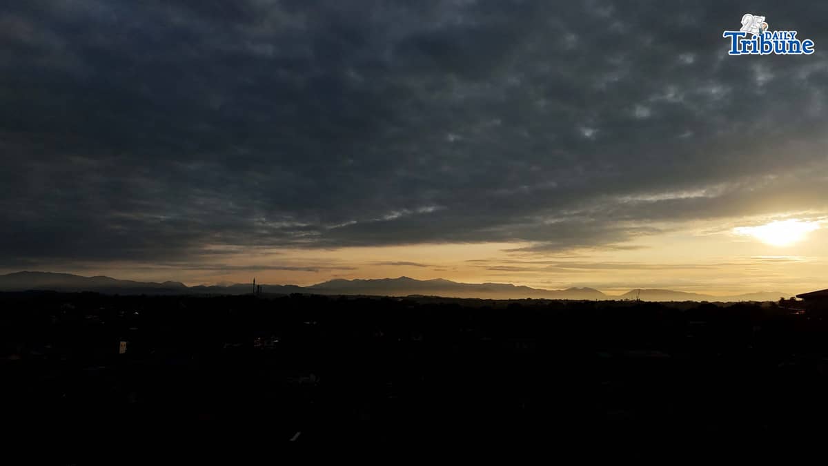 The sun briefly breaks through the clouds before dark skies take over on Thursday, Jan. 1, 2026, as seen from Caloocan City.