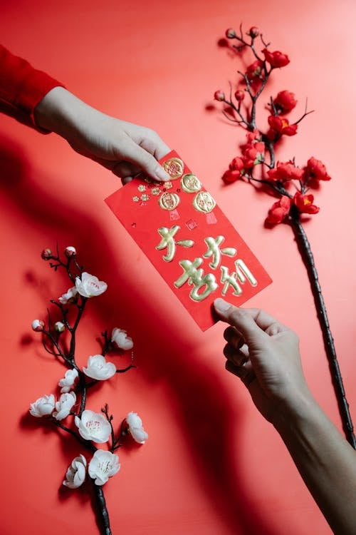A QUIET exchange of luck and prosperity, wrapped in red and tradition.