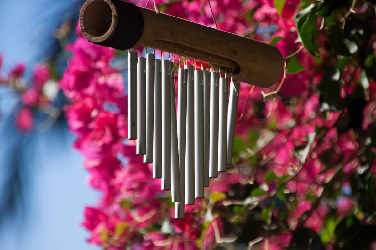 Wind chimes symbolize good fortune, peace, healing, and protection, acting as spiritual guardians to attract positive energy and ward off evil spirits.