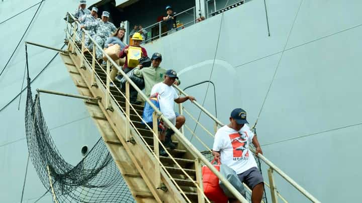 The Philippine Coast Guard (PCG) facilitated the turnover of three fisherfolk rescued by a United States (U.S.) Navy vessel, USNS Cesar Chavez (T-AKE 14), approximately 50 nautical miles west of Bolinao, Pangasinan, on January 1, 2026. (Photo courtesy of PCG)