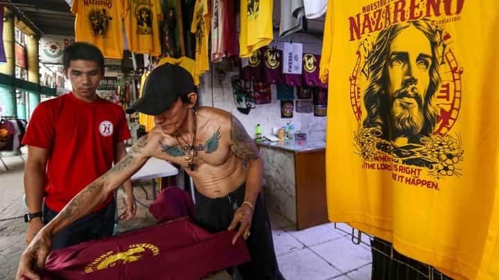 A T-shirt seller prints images of Jesus Nazareno at his shop along Alfonso Mendoza Street, Manila on Sunday ahead of the Feast of the Black Nazarene. The shirts are sold between P150 and P200.