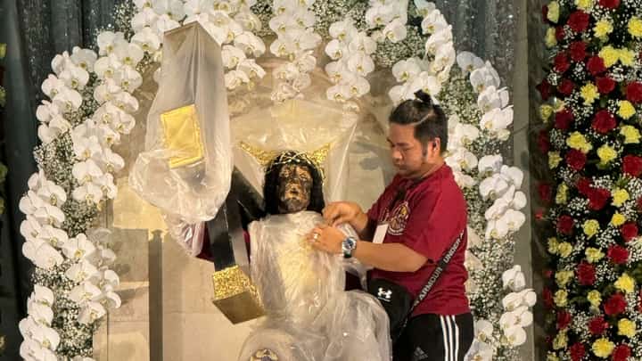 Nazareno devotee John Ray Figueroa with the original image of the Black Nazarene in Quiapo