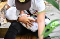 A FILIPINO mother holds her two-month-old baby near the Port of Manila. Authorities are investigating cases of parents attempting to sell infants online.