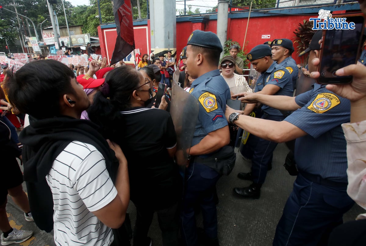 Militant groups stage a protest outside the DSWD Central Office in Batasan, Quezon City on Monday, demanding the immediate release of ₱25,000 in compensation for each family affected by recent disasters.