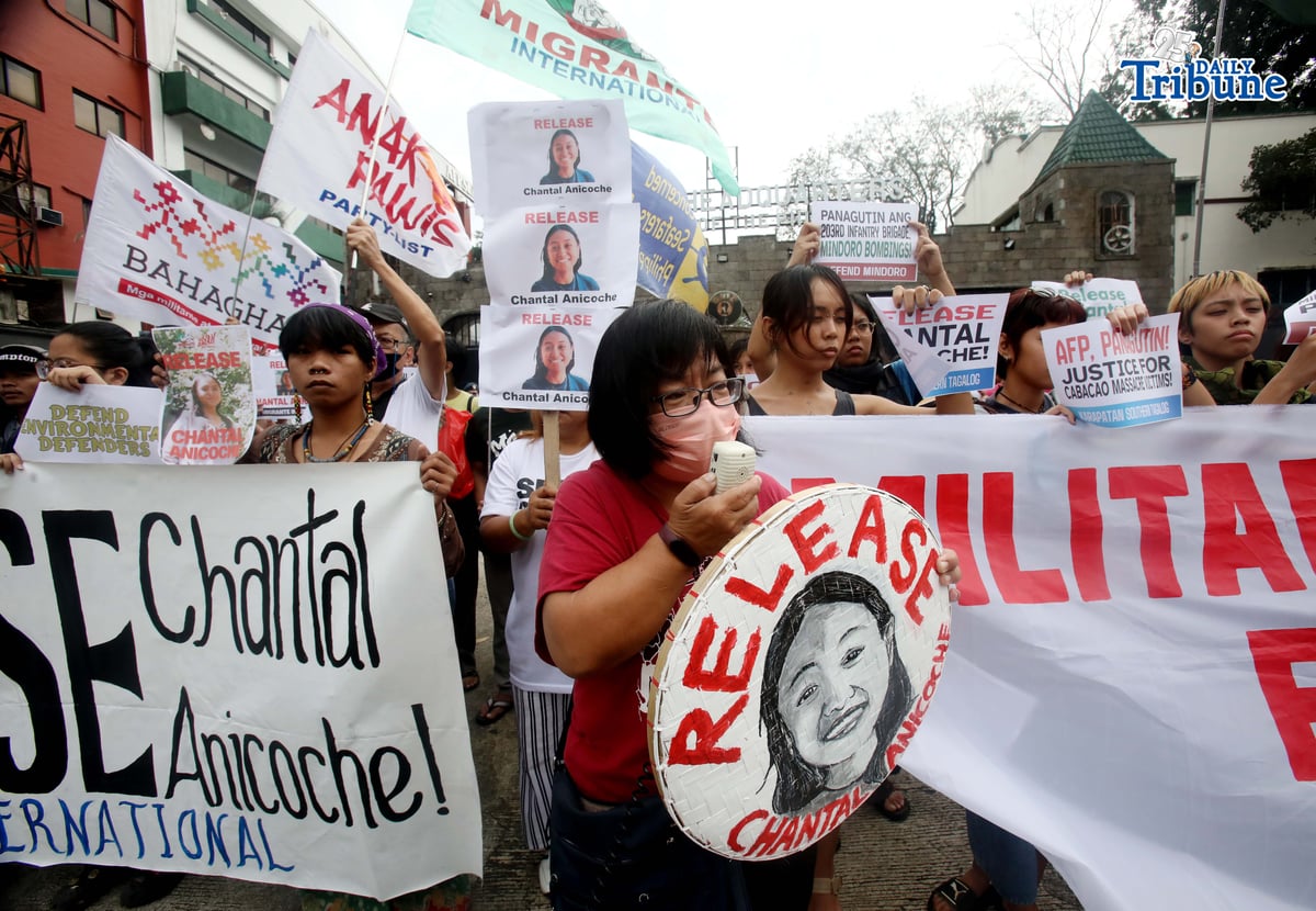 Human rights and migrant rights groups hold a protest outside Camp Aguinaldo in Quezon City on Monday, calling for the immediate release of Filipino-American activist Chantal Anicoche and condemning what they describe as her illegal detention following a reported encounter between government troops and the New People’s Army in Abra de Ilog, Occidental Mindoro, on 1 January.