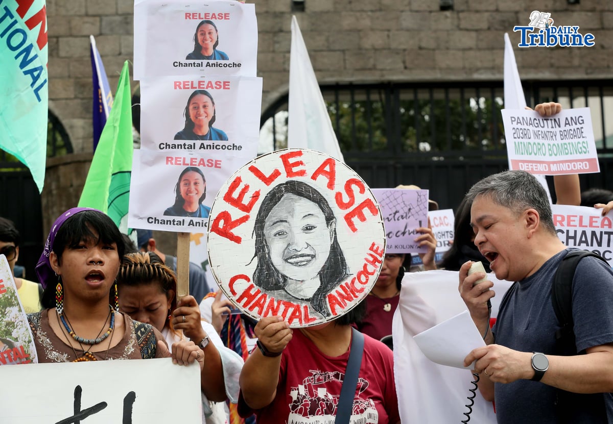 Human rights and migrant rights groups hold a protest outside Camp Aguinaldo in Quezon City on Monday, calling for the immediate release of Filipino-American activist Chantal Anicoche and condemning what they describe as her illegal detention following a reported encounter between government troops and the New People’s Army in Abra de Ilog, Occidental Mindoro, on 1 January.